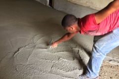 Luisito, a Maestro (construction leader), finishing a floor