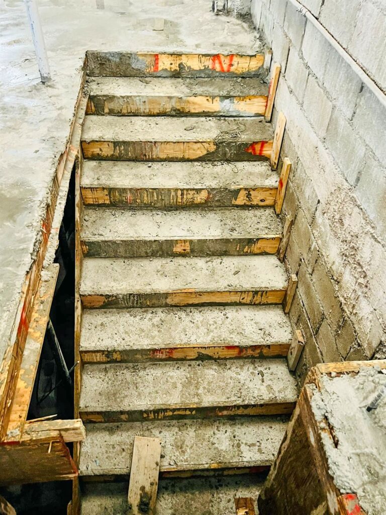 Concrete stairway leading to new second level.