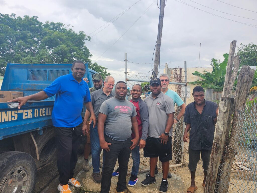 Men standing by the food distribution truck