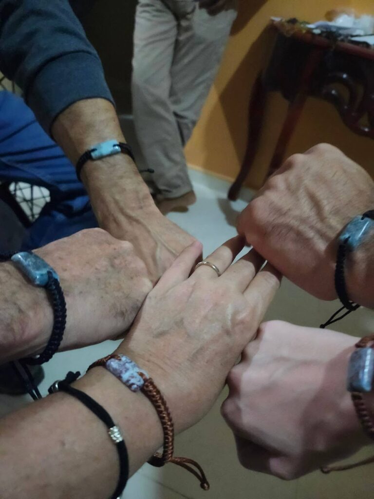 Hands with larimar bracelets circled together