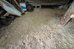 An existing dirt floor in one of the homes.